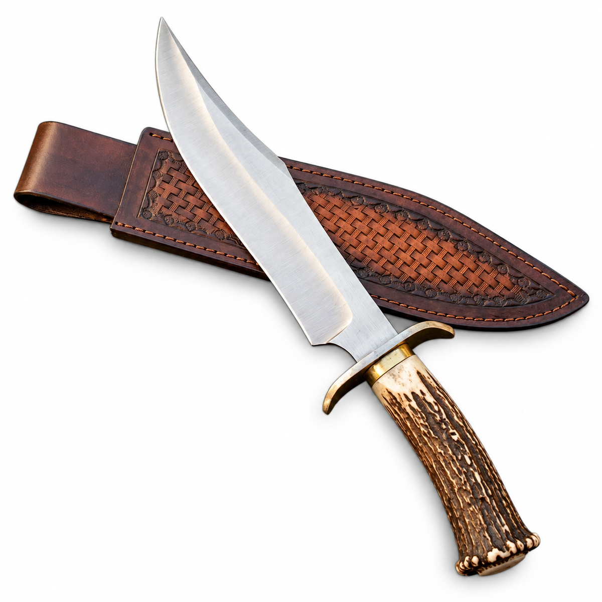 Handmade Bowie knife with natural stag horn handle beside tooled leather sheath

