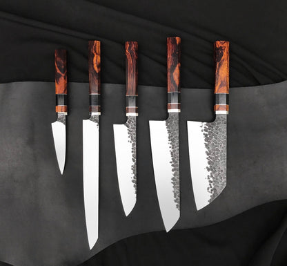 Chef kitchen knife set of five handmade knives with hammered blades and wood handles on black fabric
