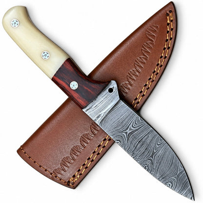 Damascus bolster and wavy layered blade pattern on a hunting knife

