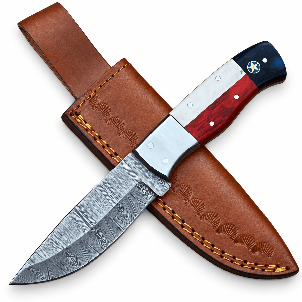 Damascus skinner knife resting on a fan-tooled leather sheath