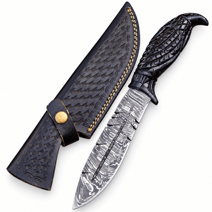 Embossed black leather sheath with contrast stitching beside a Damascus knife
