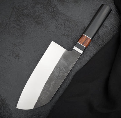 Handmade 6.5 inch kitchen knife with polished edge side and dark textured finish above
