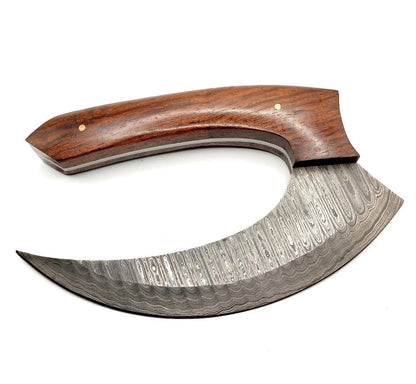 Curved Damascus steel blade of a handmade ulu knife
