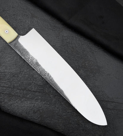 Handmade 8 inch kitchen knife with wide blade, curved tip and dark finish along the spine
