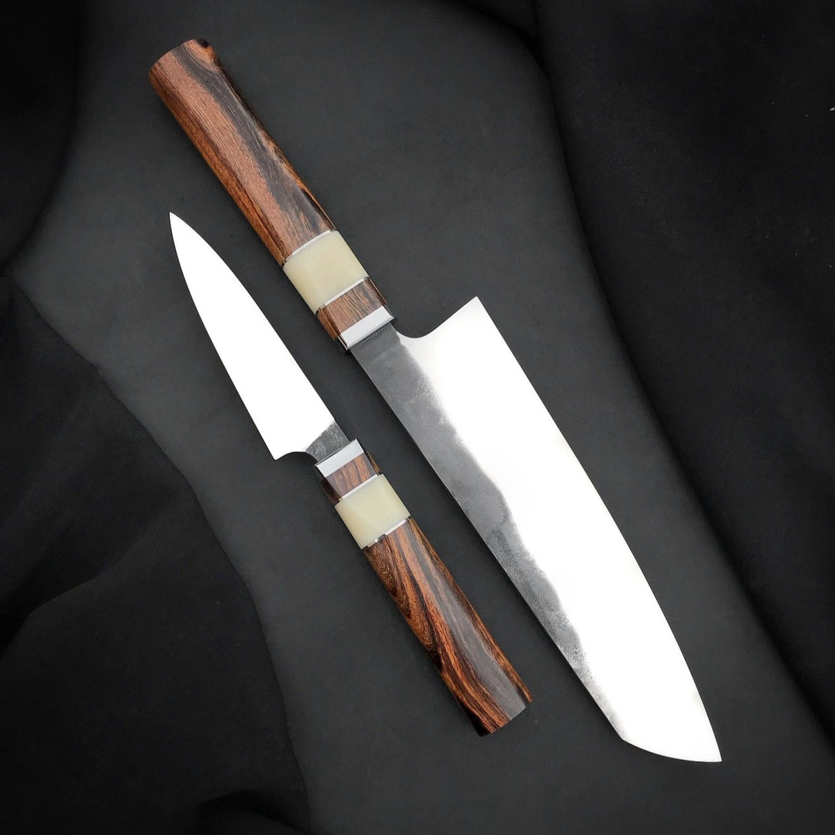 Octagonal wood knife handles with pale accent sections, thin spacers and polished collars
