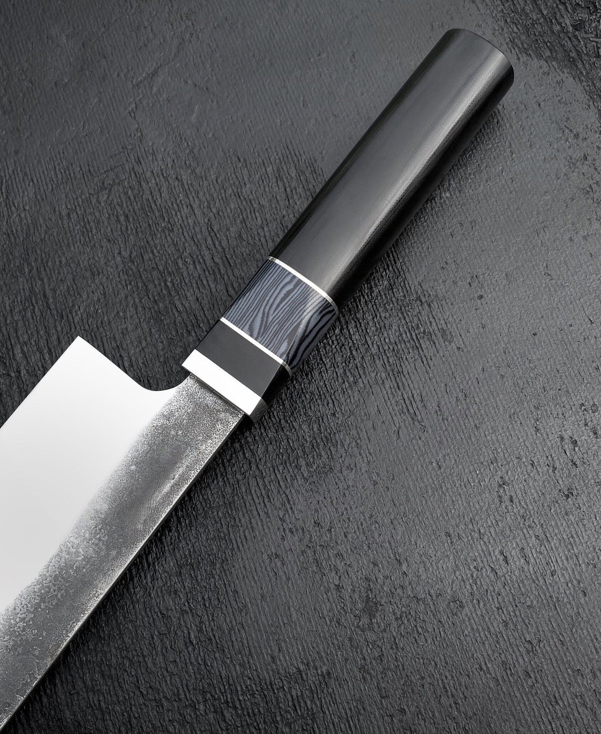 Knife handle with blue-gray striped section, thin spacers and polished collar
