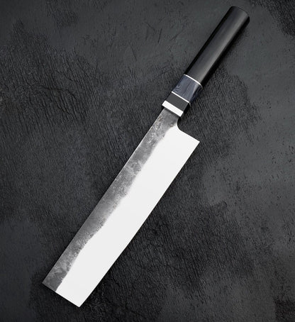 Nakiri vegetable knife with rectangular polished blade and black Micarta and wood handle on dark surface
