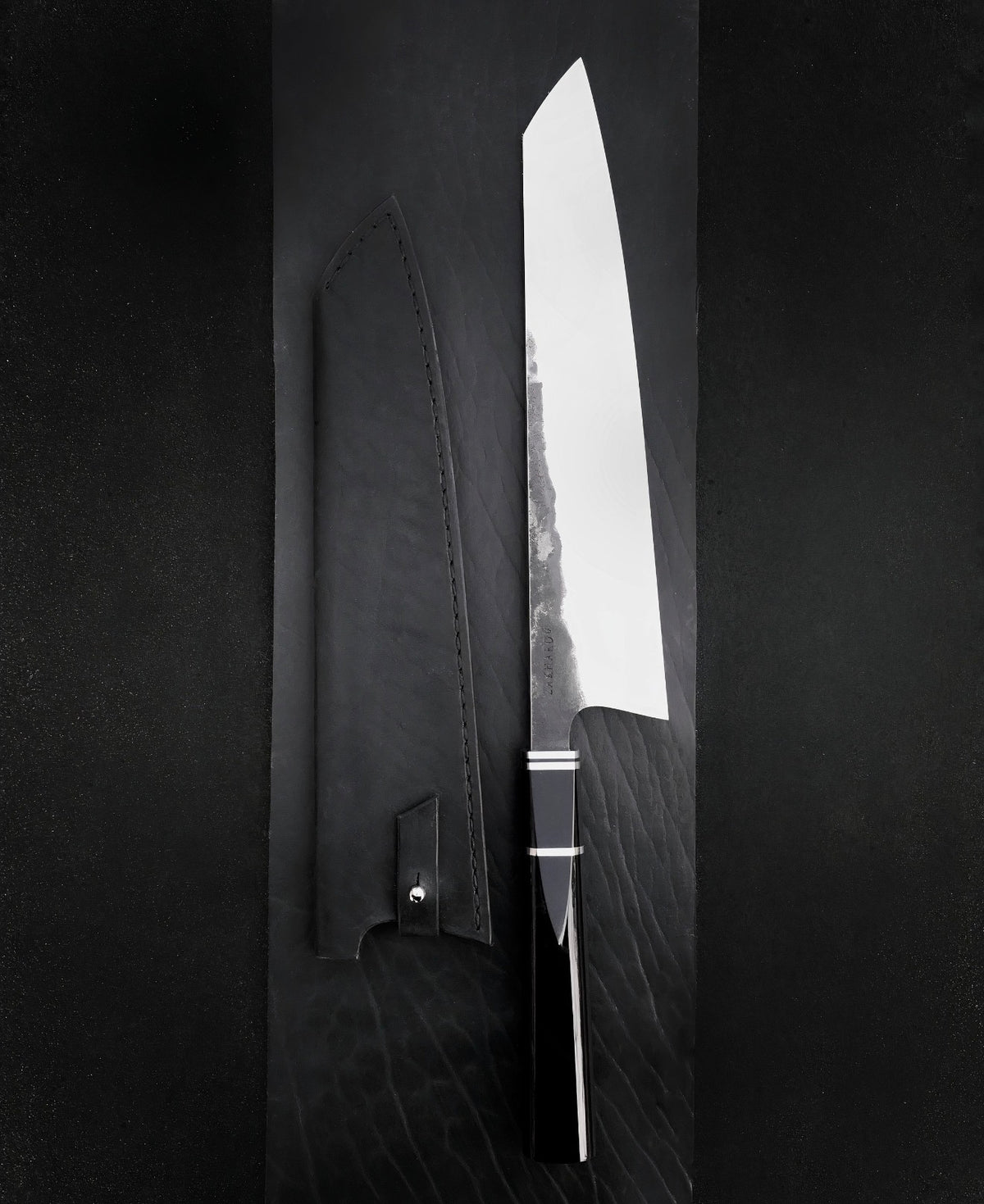 Octagonal black resin knife handle with thin light spacers and polished 440C blade