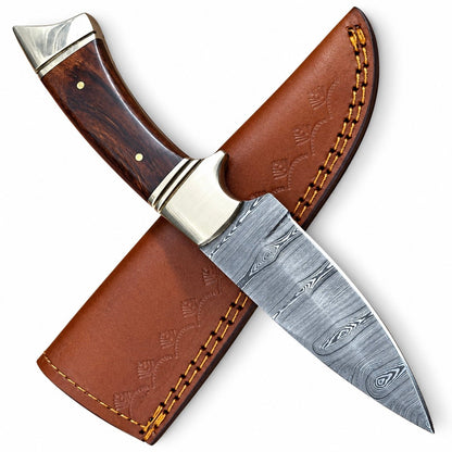 Small skinning knife with swirling Damascus pattern and polished bolster
