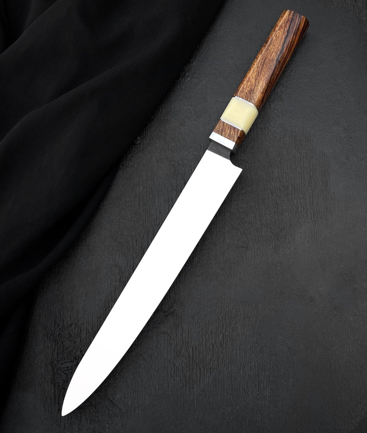 Wood knife handle with pale accent section and polished metal spacer
